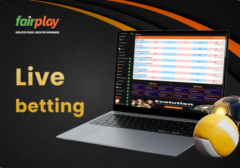 FairPlay in-play betting page on a laptop with a football and volleyballs beside it.